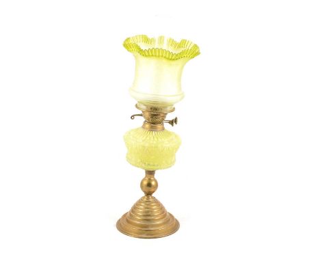 Victorian brass and vaseline glass oil lamp, with moulded green opalescent glass reservoir, the crimped shade with green tint