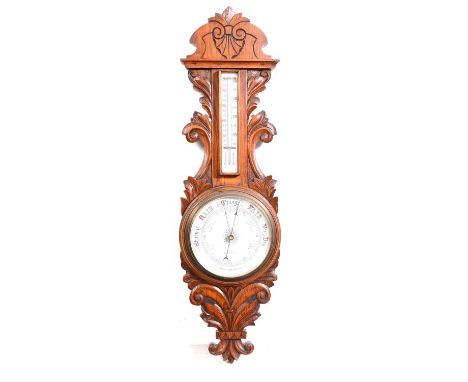 Victorian carved oak aneroid barometer and thermometer, 90cm.