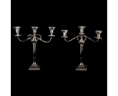 A matched pair of silver three-light candelabra, by, repectively, Britton, Gould &amp; Co, Birmingham 1930 &amp; William Adam