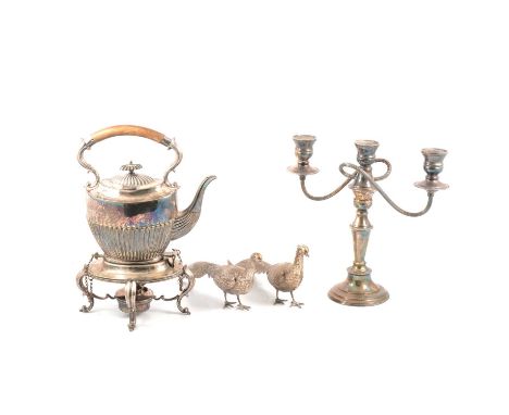 Pair of silver birds, plated kettle on stand, candelabra and three glass decanter.