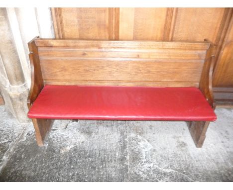 A oak pew with single panelled back and prayer book shelf to the reverse,134cm wide, 40cm deep, 81cm high Please Note this Lo