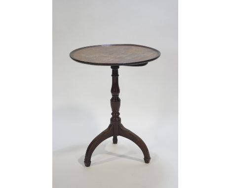 A Georgian mahogany tripod table of traditional form, the round top with decorated edge on a baluster column on three splayed