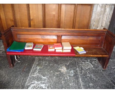 A Victorian pine pew with double paneled back and prayer book shelf to reverse with one damaged end 81 cm high, 134 cm wide, 