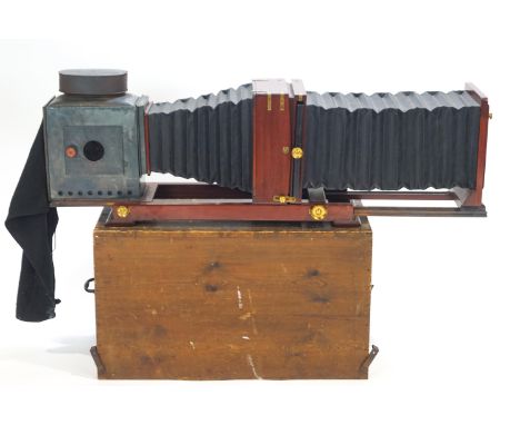 A mahogany and brass plate field camera, of massive proportions, set with an F8 Ensign symmetrical lens, 42cm high x 27cm lon