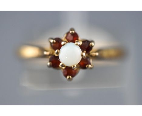 A yellow metal cluster ring set with commercial opal and garnets. Stamped Silver &amp; GP. Size: N, 2.0 grams