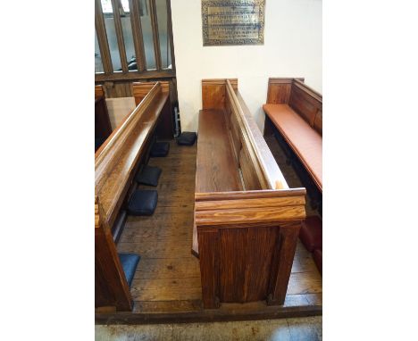 A Victorian pine pew with triple paneled back and prayer book shelf to reverse with one wall end 83cm high, 271cm wide, 48cm 