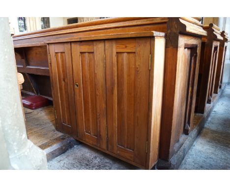 A Victorian pine pew with triple paneled back and prayer book shelf to the reverse (drilled hole) with two cupboard doors als