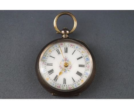 An 800 grade white metal open faced pocket watch with white ceramic floral design dial. Key wound mechanical movement, with o