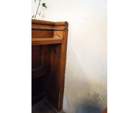 A Victorian pine pew with triple paneled back and prayer book shelf to reverse with one wall end 83cm high, 271cm wide, 48cm 