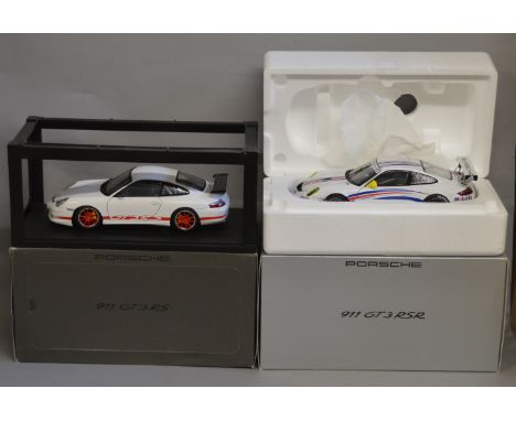 Two boxed Autoart diecast  Porsche 911 GT models in 1:18 scale, an RS model in white and an RSR in . Both appear VG in G to V