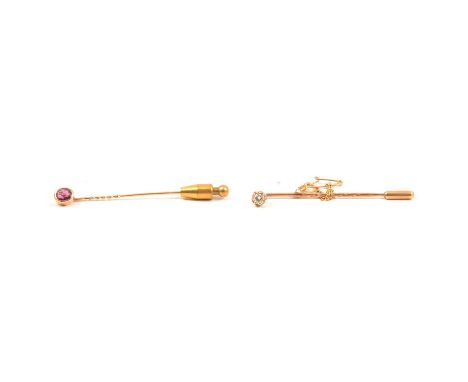 A diamond tie pin and a garnet tie pin, a diamond tie pin, the 3.8mm brilliant cut stone claw set to an unmarked yellow metal