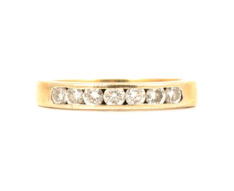 A diamond half hoop ring, the seven brilliant cut diamonds channel set in an 18 carat yellow gold 3.4mm wide mount ring size 