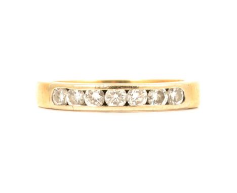 A diamond half hoop ring, the seven brilliant cut diamonds channel set in an 18 carat yellow gold 3.4mm wide mount ring size 