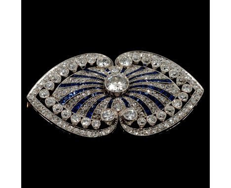 An Art Deco sapphire and diamond brooch, the oval white metal mount millegrain set with a 6mm old brilliant cut diamond to ce