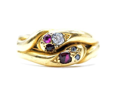 A ruby and diamond double snake head ring, one head set with an old cut diamond and two ruby eyes, the other head set with a 