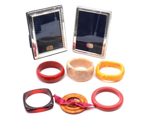 Five vintage bakelite bangles, bakelite scarf ring, puzzle ring, and silver photograph frames, two red bakelite solid bangles