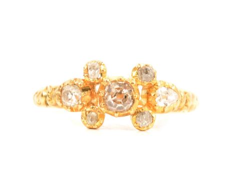 A diamond set dress ring, the seven old cut diamonds individually set in an unmarked all yellow metal mount ring size K, gros