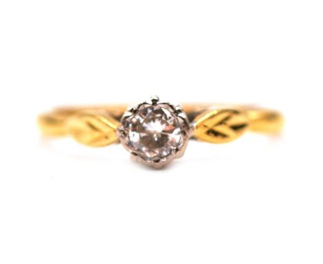 A diamond solitaire ring, the 4mm brilliant cut stone illusion set in an 18 carat yellow and white gold mount ring size O, Bi