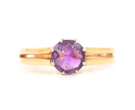 An amethyst dress ring, the 7.5mm brilliant cut stone claw set in a yellow and white gold mount ring size S, two strand shoul