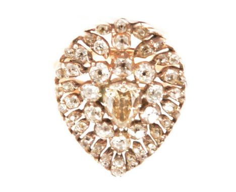 A large diamond cluster ring, a pear shaped diamond set to the centre of a large cluster mount 25x20mm, and surrounded by a f