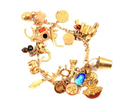 A gold charm bracelet with metal and gold charms, a 3mm gauge rectangular link chain marked 9ct, twenty-seven charms attached