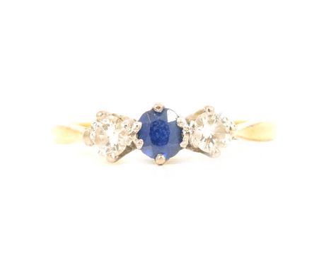 A sapphire and diamond three stone ring, an oval mixed cut sapphire and two brilliant cut diamonds claw set in a yellow and w