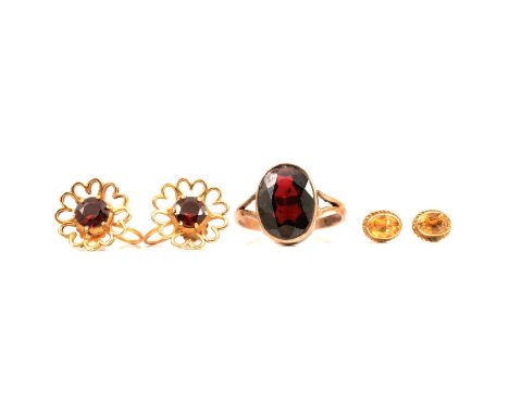 A garnet dress ring and pair of earscrews, citrine earstuds, a garnet dress ring, the oval faceted stone, 14x9mm, collet set 