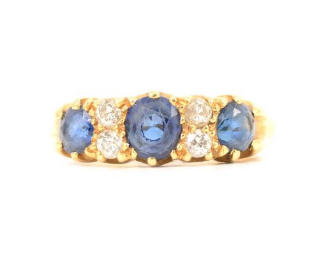 A sapphire and diamond half hoop ring, three sapphires spaced by two pairs of old cut diamonds, 7mm wide at head, in an all y