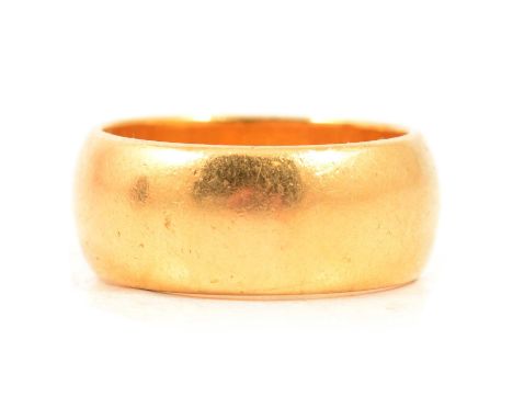 A 22 carat yellow gold wedding band, 8mm wide plain polished D shape ring size L, Birmingham 1960, 11g.