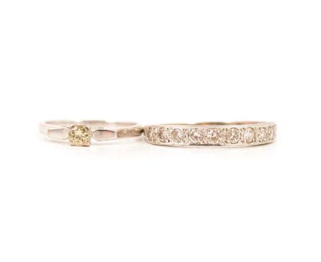 A diamond solitaire ring and a diamond half eternity ring, the 3.5mm diamond solitaire four claw set in an all white metal mo