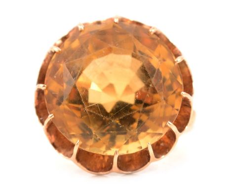 A citrine dress ring, the round mixed cut citrine, 16.5mm diameter, claw set in an unmarked yellow metal mount ring size appr