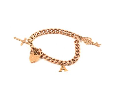 A 9 carat yellow gold hollow curb link bracelet and charms, the 6.5mm gauge hollow curb link bracelet with padlock fastener m