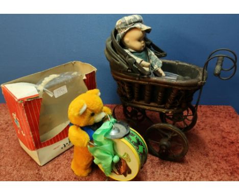 Small dolls vintage metal &amp; wood pram with a bisque headed doll and a battery operated drumming teddy bear 