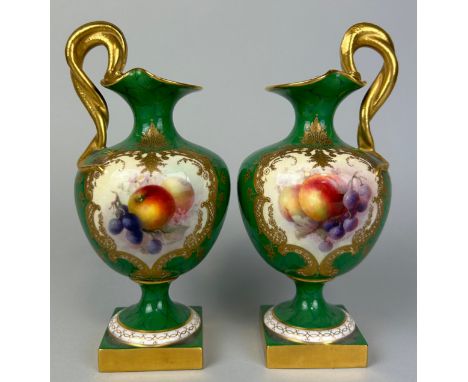 A PAIR OF ROYAL WORCESTER GREEN PAINTED PEDESTAL VASES BY RICHARD SEBRIGHT WITH GILT SERPENT HANDLESPainted with scenes of ap