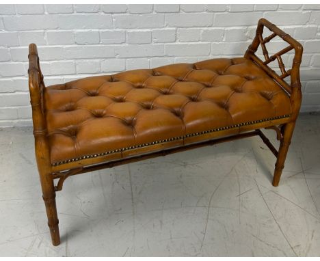 A FAUX BAMBOO WINDOW SEAT IN THE CHINESE CHIPPENDALE STYLE UPHOLSTERED IN BUTTON BACK TAN LEATHER FABRIC,  89cm x 62cm x 37cm