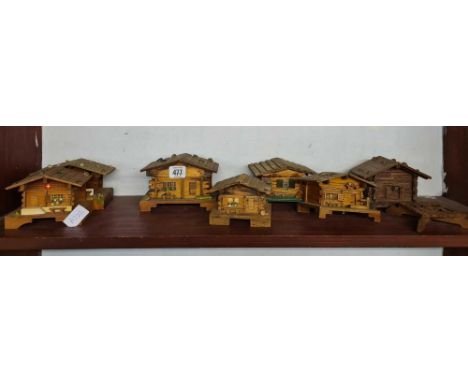 SHELF OF MINIATURE LOG SHACKS