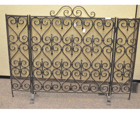 A three fold iron and mesh fire screen, 73cm x 60cm when closed