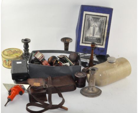 A collection of mixed items, including tools, candle sticks and much more