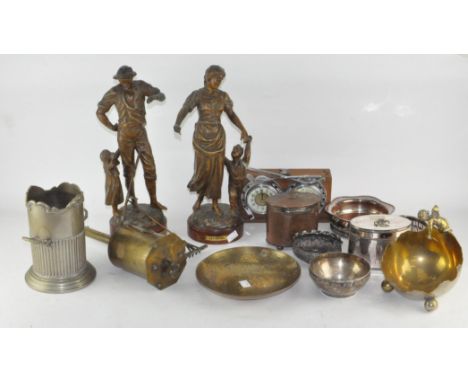 An assortment of metalware, to include a pair of large figures depicting parents with children, silver plated wine bottle coa