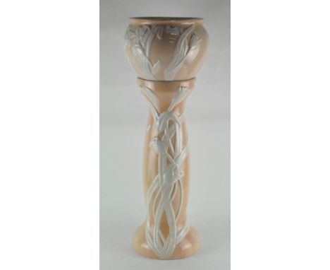 A ceramic jardiniere on matching ceramic stand, decorated with floral motifs, 78cm high