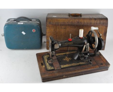 A Harris cased sewing machine, together with a Kodak projector