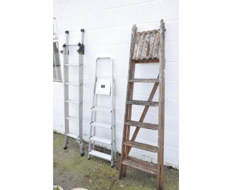 One extending metal ladder, a wooden A frame and one step ladder