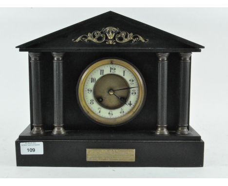A late Victorian slate mantle clock, the enamel dial with Arabic numerals denoting hours, dated 1897, 26cm x 31cm