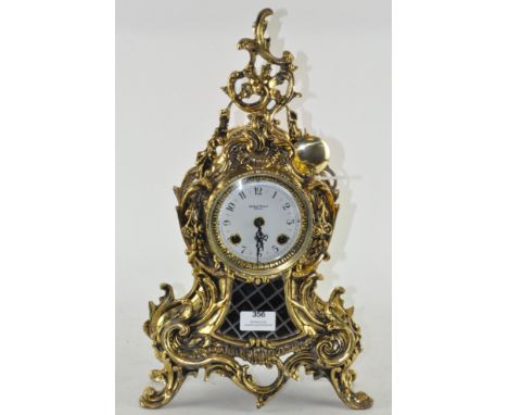 A modern gilt mantel clock in the rococo style, retailed by Robert Grant of London, the enamel dial with Arabic numerals deno