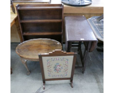 An oak open bookcase, a gateleg table, a walnut coffee table and an embroidered fire screen 