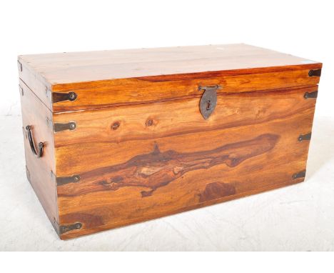 A contemporary hardwood blanket box chest trunk of Indian origin. The chest of rectangular form with hinged lid, ebonised met