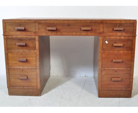 A 1930's Art Deco mahogany twin pedestal office desk. Each pedestal raised on a plinth base with pull handles to the drawers.