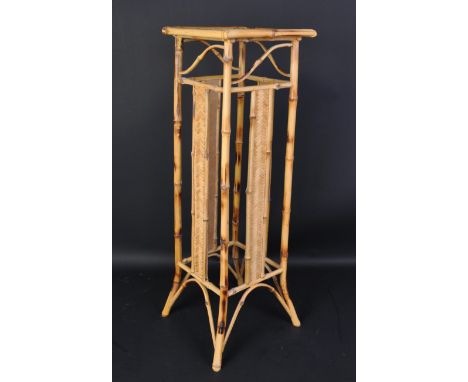 A vintage 1970s bohemian style bamboo and rattan&nbsp;Jardiniere / plant stand of rectangular form with woven rattan side pan