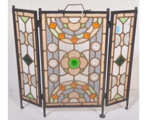 A 20th century stained and leaded coloured glass triptych fire screen / discretion panel. Metal frame with multicoloured stai