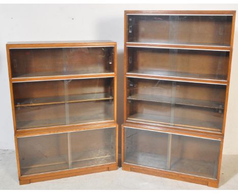 Two retro vintage mid 20th century Minty glazed teak cased bookcases having a series of glass sliding doors compartments open